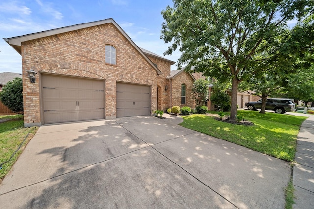 334 Hawthorn Dr, Fate, TX 75087 - traditional-style house with brick siding, driveway, a front yard, and a garage