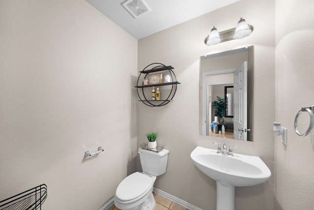 334 Hawthorn Dr, Fate, TX 75087 - half bathroom featuring toilet, tile patterned floors, and baseboards