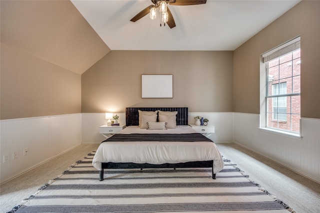8250 Library St, Frisco, TX 75034 - bedroom featuring a wainscoted wall, carpet, ceiling fan, and vaulted ceiling