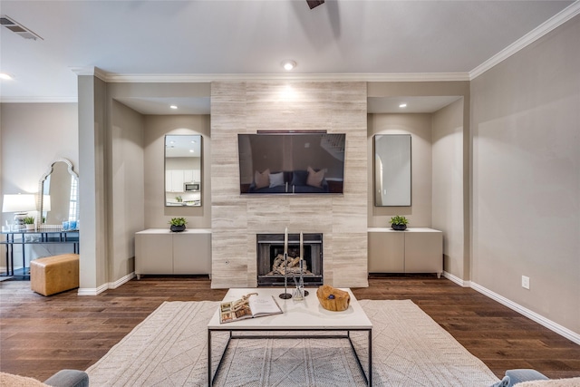 8250 Library St, Frisco, TX 75034 - living area with ornamental molding, a tile fireplace, wood finished floors, and baseboards