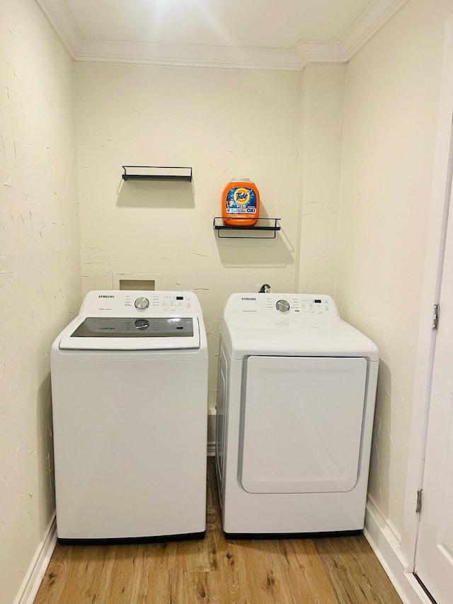 2605 Twinpost Ct, Irving, TX 75062 - washroom with washer and clothes dryer, crown molding, and light wood-style floors