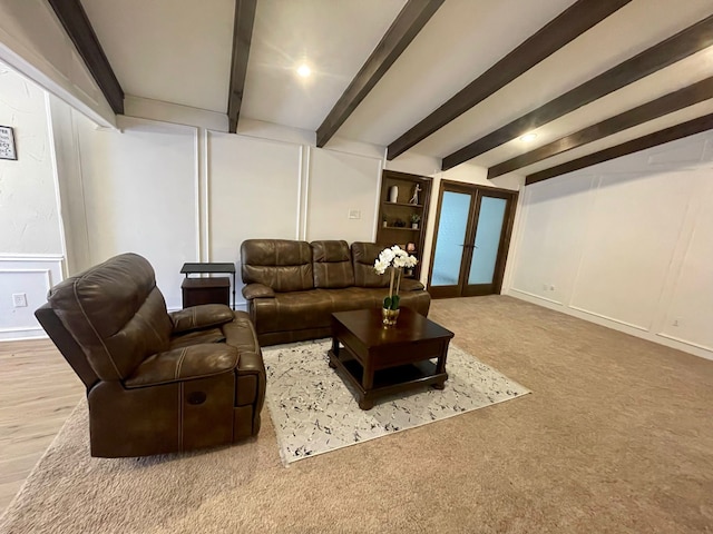2605 Twinpost Ct, Irving, TX 75062 - living room with beam ceiling, french doors, a decorative wall, carpet flooring, and baseboards