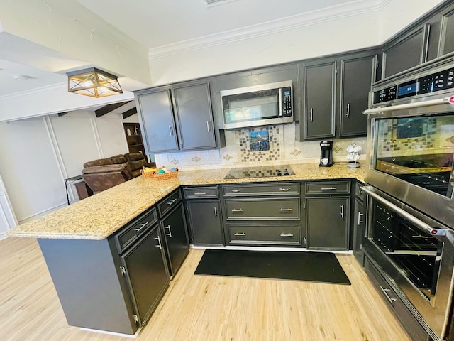 2605 Twinpost Ct, Irving, TX 75062 - kitchen with appliances with stainless steel finishes, a peninsula, ornamental molding, light wood-style flooring, and decorative backsplash