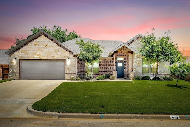 430 Mitchell Blvd, Weatherford, TX 76087 - view of front of home featuring stone siding, a garage, concrete driveway, a yard, and roof with shingles