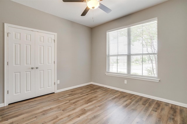 430 Mitchell Blvd, Weatherford, TX 76087 - unfurnished bedroom featuring light wood finished floors, a closet, baseboards, and a ceiling fan