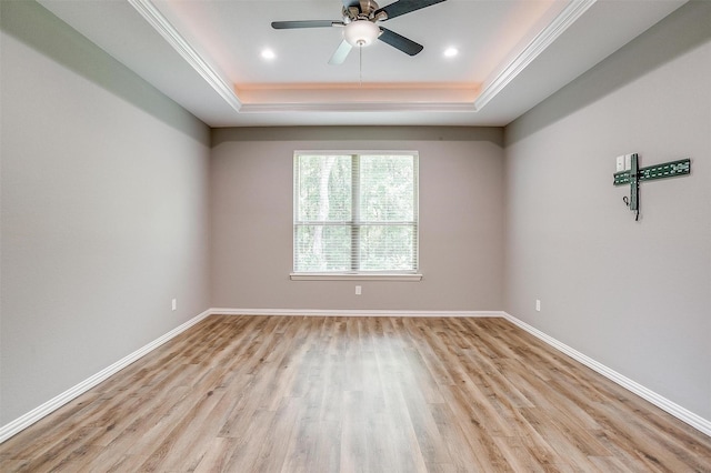 430 Mitchell Blvd, Weatherford, TX 76087 - empty room with a raised ceiling, light wood-style flooring, ceiling fan, baseboards, and crown molding