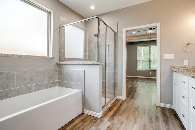 430 Mitchell Blvd, Weatherford, TX 76087 - full bathroom with a shower stall, a garden tub, wood finished floors, vanity, and recessed lighting