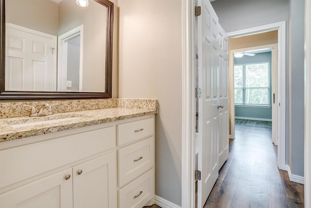 430 Mitchell Blvd, Weatherford, TX 76087 - bathroom featuring vanity, wood finished floors, baseboards, and a ceiling fan