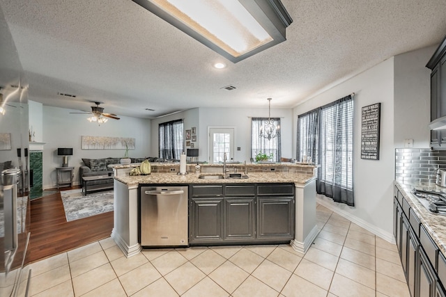 2508 Springhill Dr, Grapevine, TX 76051 - kitchen featuring a sink, dishwasher, open floor plan, a chandelier, and light tile patterned flooring