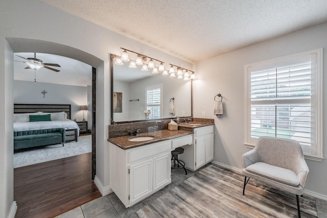 2508 Springhill Dr, Grapevine, TX 76051 - full bathroom with ensuite bathroom, double vanity, a textured ceiling, wood finished floors, and a ceiling fan