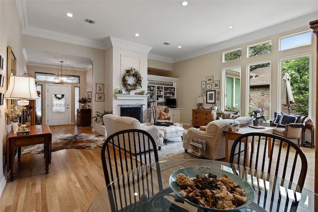 6518 Laurel Valley Rd, Dallas, TX 75248 - dining space with light wood-style floors, a fireplace, recessed lighting, and ornamental molding