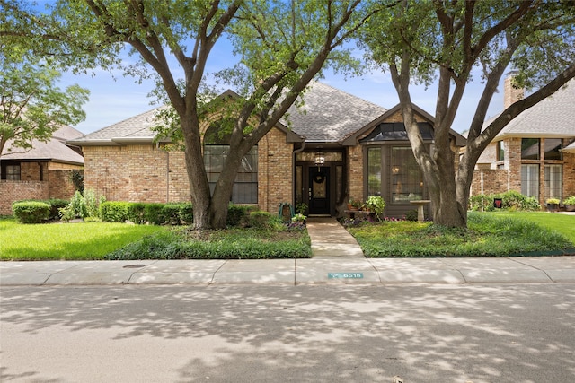 6518 Laurel Valley Rd, Dallas, TX 75248 - view of front facade featuring brick siding, a front yard, and roof with shingles