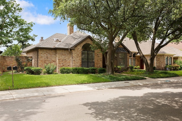 6518 Laurel Valley Rd, Dallas, TX 75248 - view of front of property with brick siding, a front yard, and a chimney