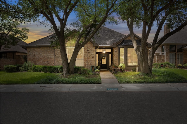 6518 Laurel Valley Rd, Dallas, TX 75248 - view of front of house with brick siding, a shingled roof, and a lawn