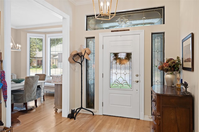6518 Laurel Valley Rd, Dallas, TX 75248 - foyer entrance with a chandelier, light wood finished floors, crown molding, and baseboards