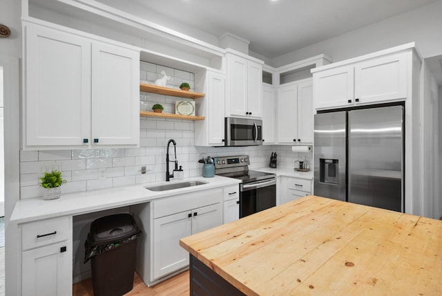 2415 Vz County Road 2624, Wills Point, TX 75169 - kitchen featuring appliances with stainless steel finishes, a sink, butcher block counters, tasteful backsplash, and open shelves