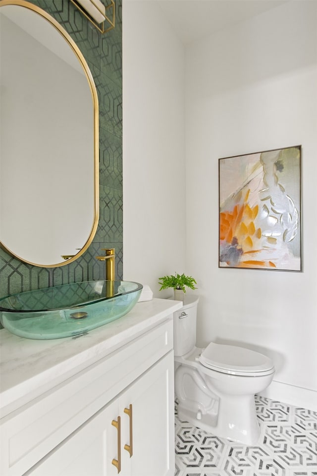 9974 Witham St, Dallas, TX 75220 - bathroom featuring toilet, vanity, and baseboards