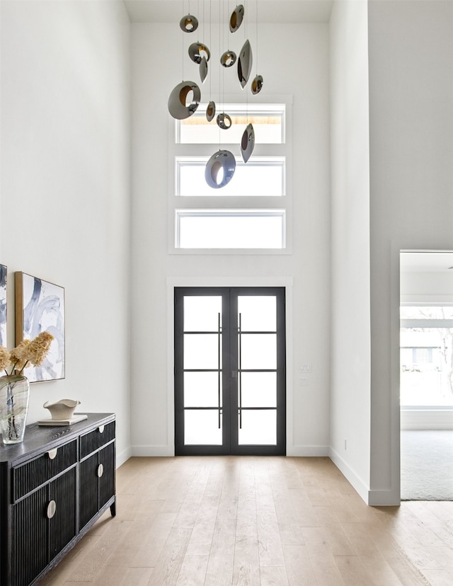 9974 Witham St, Dallas, TX 75220 - foyer entrance with a high ceiling, french doors, wood finished floors, and baseboards