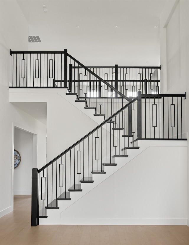 9974 Witham St, Dallas, TX 75220 - stairs featuring a towering ceiling, baseboards, and wood finished floors
