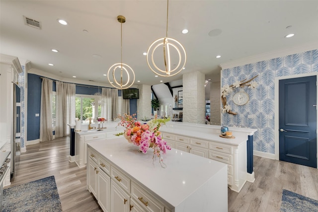 1705 Bison Meadow Ln, Heath, TX 75032 - kitchen with wallpapered walls, a large island, baseboards, ornamental molding, and a chandelier