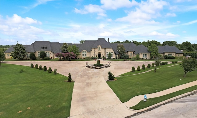 1705 Bison Meadow Ln, Heath, TX 75032 - view of front of home with curved driveway, stone siding, and a front lawn