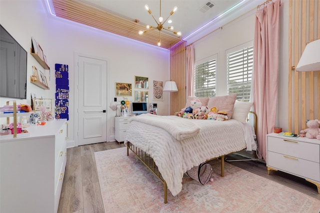 1705 Bison Meadow Ln, Heath, TX 75032 - bedroom with a chandelier and light wood-style flooring