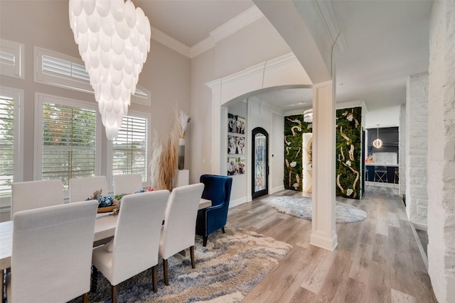 1705 Bison Meadow Ln, Heath, TX 75032 - dining space with arched walkways, ornamental molding, wood finished floors, and a high ceiling
