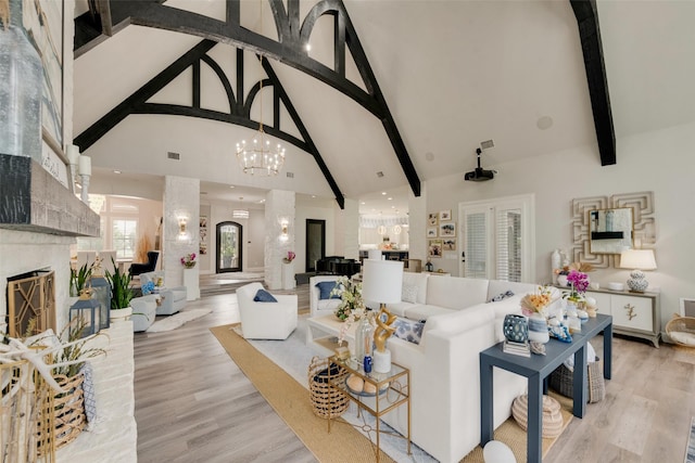 1705 Bison Meadow Ln, Heath, TX 75032 - living room featuring high vaulted ceiling, a chandelier, a premium fireplace, beamed ceiling, and light wood-type flooring