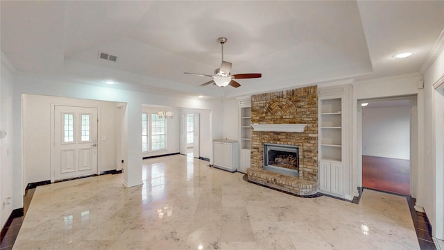 2212 Creekwood Ct, Flower Mound, TX 75028 - unfurnished living room with a tray ceiling, built in shelves, crown molding, ceiling fan, and baseboards