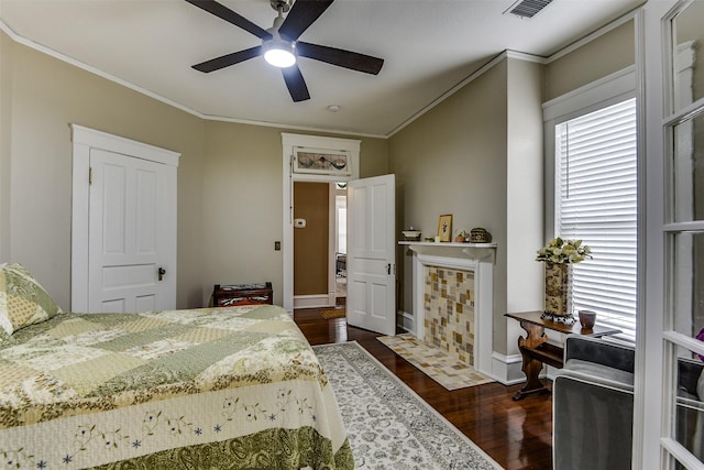 520 N College St, Waxahachie, TX 75165 - bedroom with dark wood finished floors, baseboards, crown molding, and ceiling fan