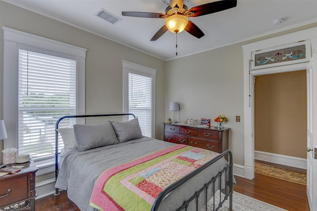 520 N College St, Waxahachie, TX 75165 - bedroom with dark wood-style flooring, ornamental molding, a ceiling fan, and baseboards