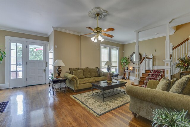 520 N College St, Waxahachie, TX 75165 - living area featuring healthy amount of natural light, stairs, ceiling fan, wood finished floors, and ornamental molding