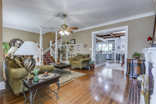 520 N College St, Waxahachie, TX 75165 - living room with crown molding, wood finished floors, a ceiling fan, coffered ceiling, and stairs