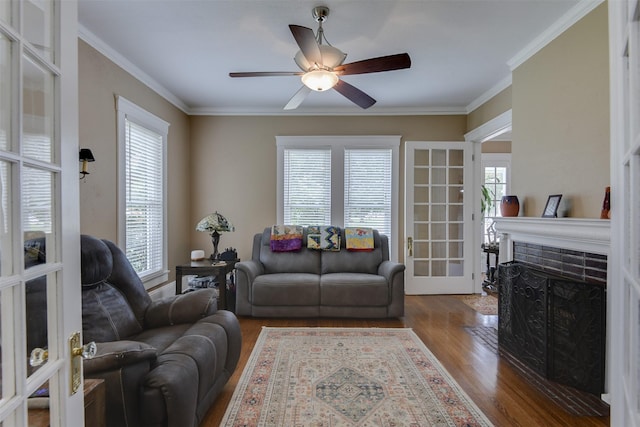 520 N College St, Waxahachie, TX 75165 - living area with wood finished floors, a fireplace with flush hearth, a ceiling fan, and ornamental molding