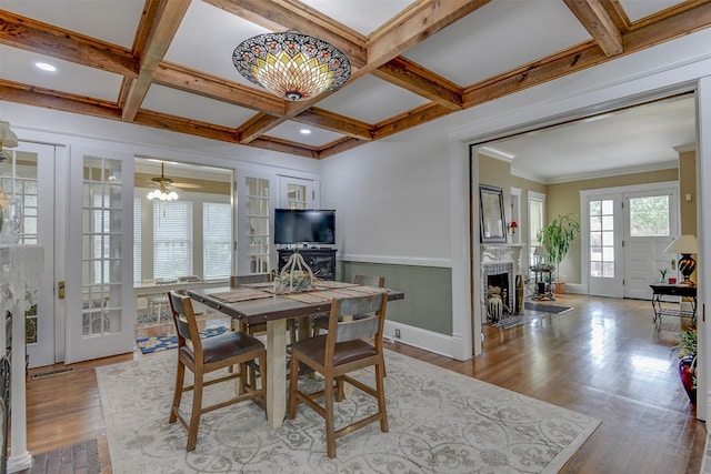 520 N College St, Waxahachie, TX 75165 - dining space featuring a fireplace with flush hearth, wood finished floors, beamed ceiling, baseboards, and coffered ceiling