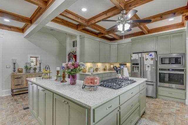 520 N College St, Waxahachie, TX 75165 - kitchen with appliances with stainless steel finishes, a ceiling fan, a center island, coffered ceiling, and green cabinetry