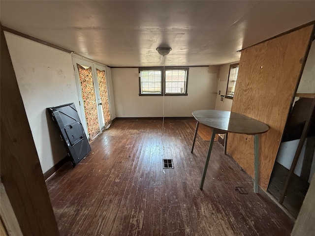 309 E Housley St, Strawn, TX 76475 - unfurnished dining area with wood-type flooring and baseboards