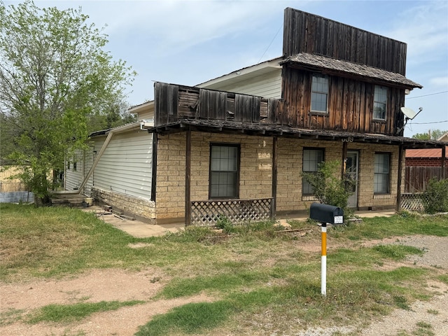 309 E Housley St, Strawn, TX 76475 - view of front of property featuring a front yard and board and batten siding