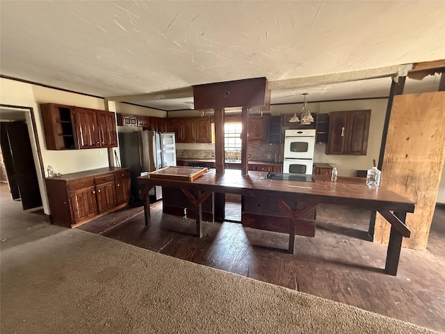 309 E Housley St, Strawn, TX 76475 - kitchen featuring freestanding refrigerator, white double oven, dark brown cabinetry, open shelves, and dark wood-style flooring
