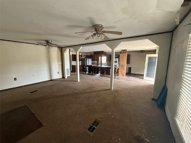 309 E Housley St, Strawn, TX 76475 - unfurnished living room featuring ceiling fan, carpet, and baseboards