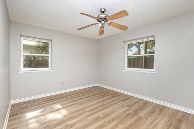 2200 Clover Park Dr, Arlington, TX 76013 - spare room with light wood-type flooring, ceiling fan, and a textured ceiling