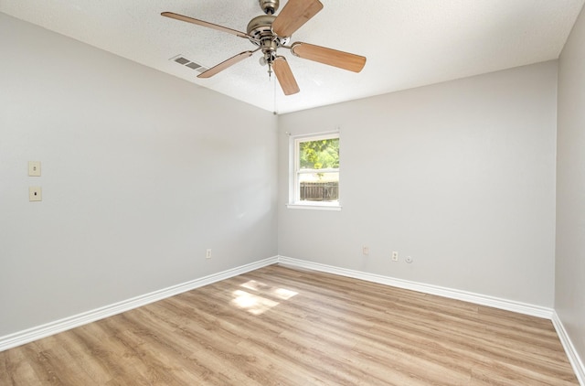 2200 Clover Park Dr, Arlington, TX 76013 - empty room with light wood finished floors, ceiling fan, and a textured ceiling