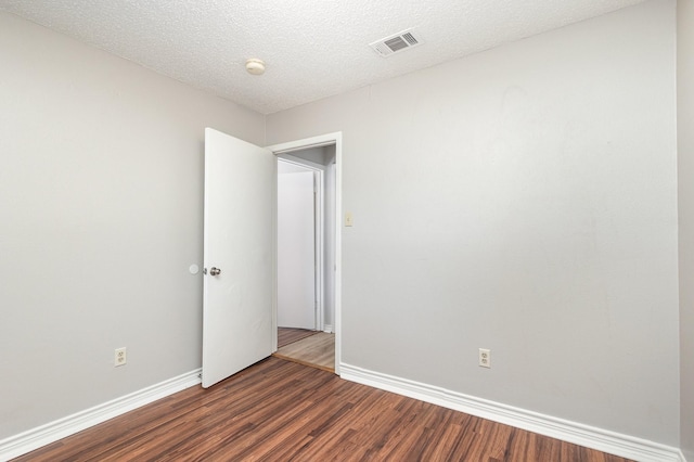 2200 Clover Park Dr, Arlington, TX 76013 - empty room with dark wood finished floors, a textured ceiling, and a smoke detector