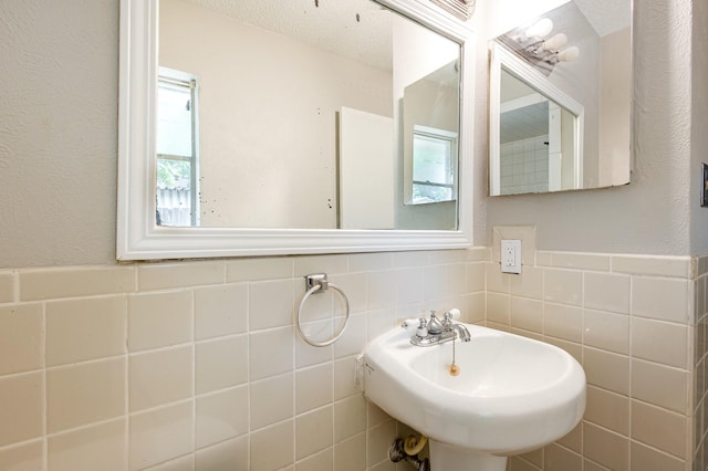 2200 Clover Park Dr, Arlington, TX 76013 - bathroom featuring tile walls and a wainscoted wall