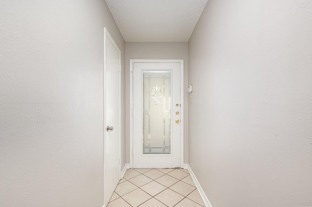 2200 Clover Park Dr, Arlington, TX 76013 - entryway featuring light tile patterned flooring and a textured ceiling