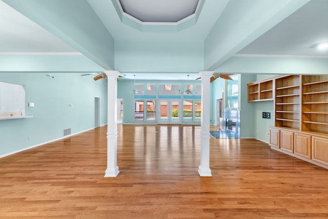 2621 Brennan Ct, Plano, TX 75075 - unfurnished living room featuring ornate columns, ceiling fan, light wood-type flooring, crown molding, and baseboards