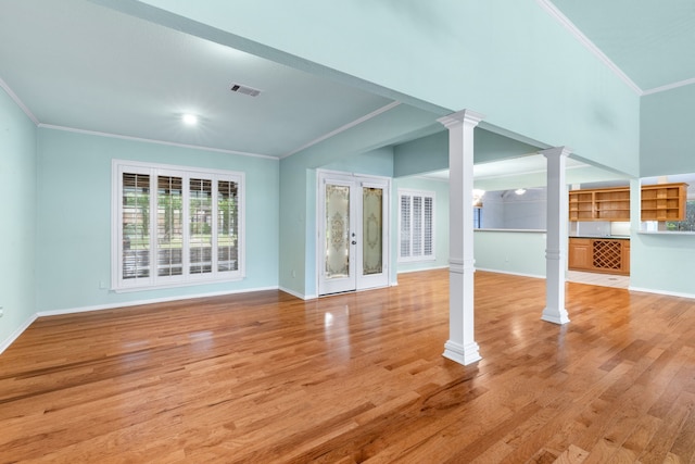 2621 Brennan Ct, Plano, TX 75075 - unfurnished living room with decorative columns, crown molding, baseboards, and light wood-style flooring