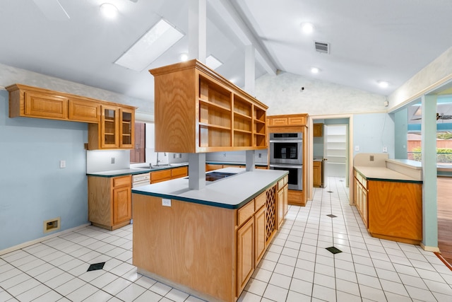 2621 Brennan Ct, Plano, TX 75075 - kitchen featuring double oven, open shelves, light tile patterned floors, and plenty of natural light