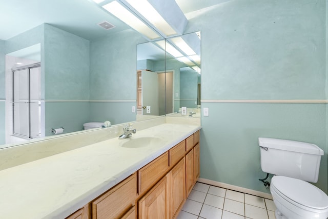 2621 Brennan Ct, Plano, TX 75075 - bathroom with toilet, vanity, tile patterned floors, a shower with shower door, and baseboards