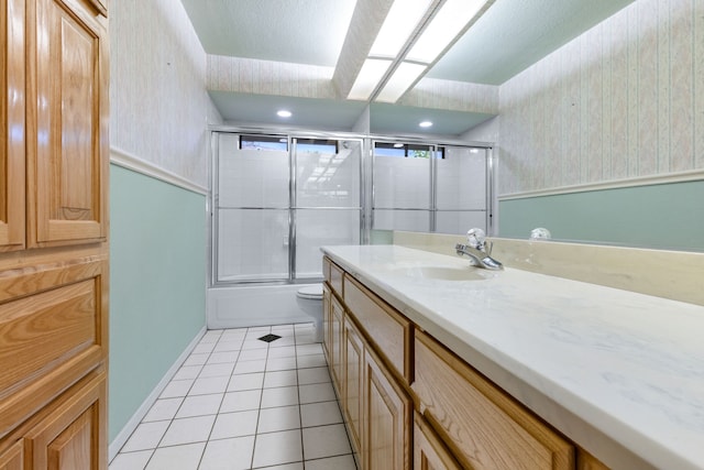 2621 Brennan Ct, Plano, TX 75075 - full bathroom featuring wallpapered walls, vanity, tile patterned flooring, bath / shower combo with glass door, and toilet